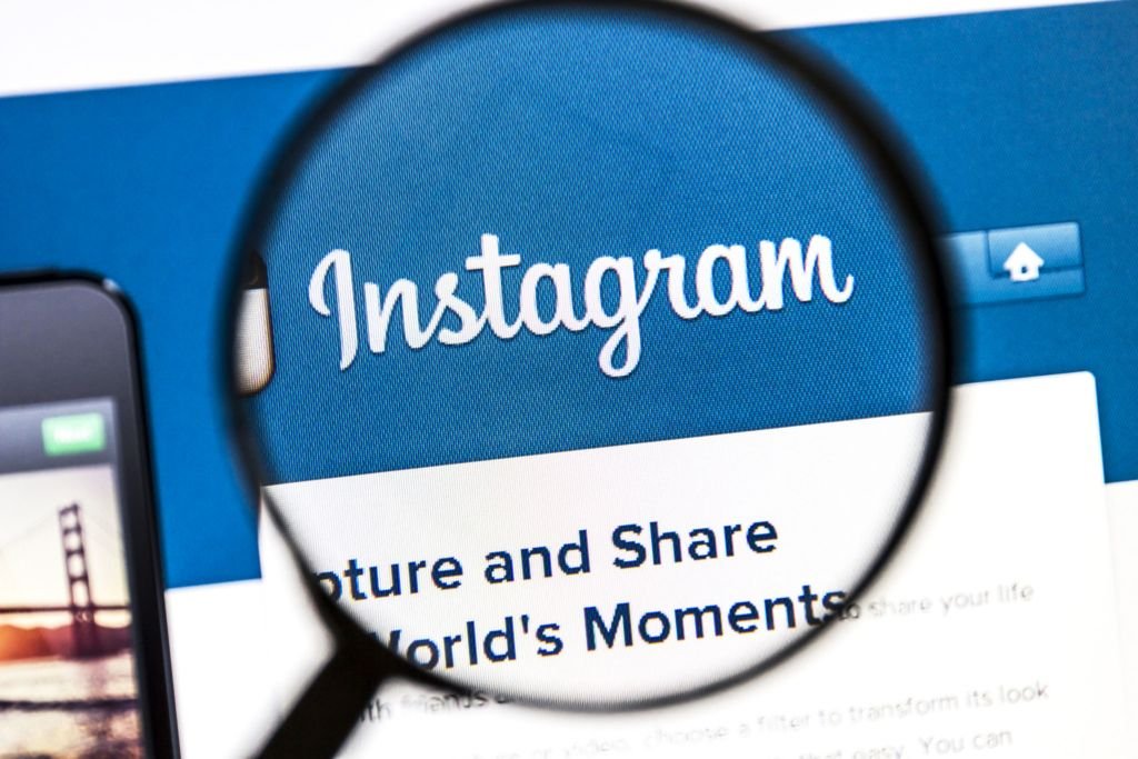 Ostersund, Sweden - August 3, 2014: Close up of instagram website under a magnifying glass.Instagram is an online mobile photo-sharing, video-sharing and social networking service.